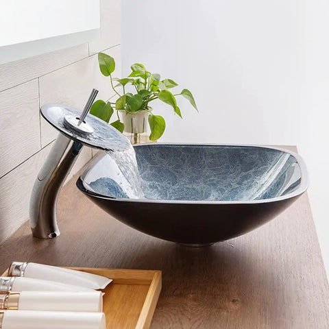 Slick Square Tempered Glass Vessel Sink For Modern Bathroom Vanity Countertops with waterfall feature on wood countertop.