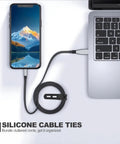 Reusable Silicone Cable Ties for Chargers and Home Office Cords, holding wrapped cable connected to phone and laptop.