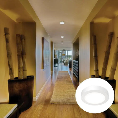 Slick 4 Inch Led Ceiling Light Low Profile Surface Mount Downlight Wet Rated Matte White Trim illuminates hallway.
