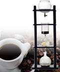 Retro Ice Drip Coffee Maker And Cold Brew Tower With Pine Wood Base And Clear Glass Carafe, brewing process in action.