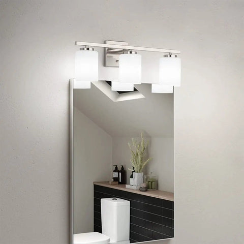 22 Inch 3 Light Modern Bathroom Vanity Light With Etched White Glass Shades In Brushed Nickel Finish ETL Listed Up Or Down Mount Bulbs Not Included Sleek Dope Look For Hallway Or Powder Room Use mounted above a rectangular mirror in a stylish bathroom setting.