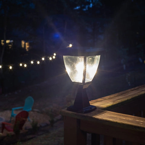 Inversee Outdoor Solar Post Light With 3 Mount Options illuminating a deck railing at night, warm white LED glowing.