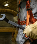 Worker holding Spud Wrench 3/4-Inch Bolt For Heavy Nuts, extra heavy-duty head, 1-1/4-Inch opening, in factory setting