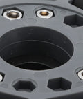 Omni wheel hub plate close-up, grey nylon with metal mounting screws around central bore