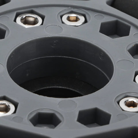 Omni wheel hub plate close-up, grey nylon with metal mounting screws around central bore