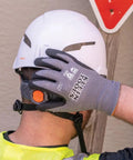 Cut Resistant Nitrile Coated Work Gloves With HPPE, Touchscreen Compatible, ANSI A4, worn by worker adjusting helmet