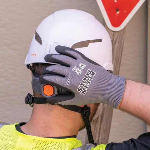 Cut Resistant Nitrile Coated Work Gloves With HPPE, Touchscreen Compatible, ANSI A4, worn by worker adjusting helmet