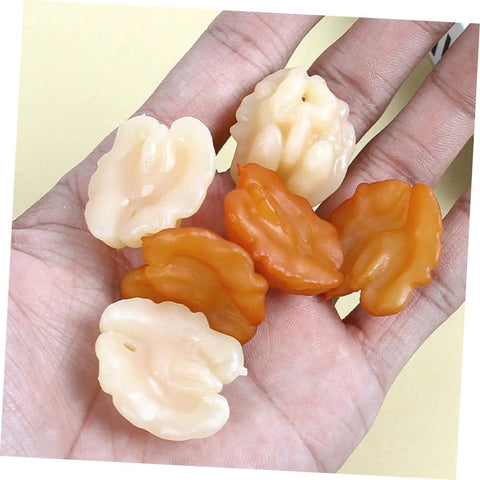 Hand holding lifelike artificial walnut miniatures for 18Pcs Lifelike Walnut Models For DIY Crafts And Home Decor Dope Realistic Artificial Nuts.