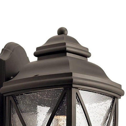 Detail view of Tangier Thirteen Point Five Inch One Light Outdoor Wall Lantern in Olde Bronze with clear seeded glass.
