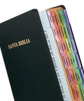 No Fuss Rainbow Spanish Catholic Bible Indexing Tabs, colorful self-adhesive page markers on a black Bible.