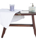 Satori Teak Shower Bench for Adults and Seniors, 24 Inch Compact Bath Seat with Brown Finish, styled with towel and toiletries