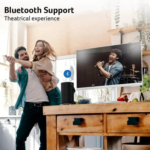 Couple enjoying music in room with 27 Inch Smart Monitor With WebOS For Streaming TV And Gaming Bluetooth Wireless Projection Screen Mirroring IoT Hub For Smart Home Height Adjustable Stand With Swivel Tilt And Pivot Dual 3W Speakers sRGB 99 Percent.