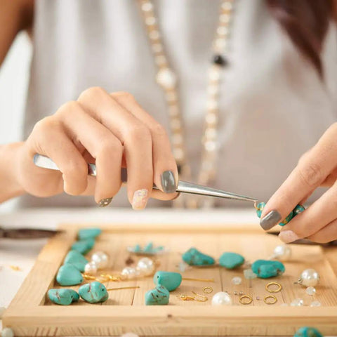Woman using tweezers from All In One Jewelry Repair Kit With 1200 Jump Rings And Lobster Clasps, Pliers, Tweezers, And Opener