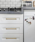 Two Pack 12 Inch Center To Center Brushed Brass Cabinet Pulls Set installed on white kitchen drawers