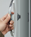 Hand holding Easy Grip Cabinet Door Latches And Pull Handles For Home Office And Locker Use Durable Push Button Closures Hardware Assorted