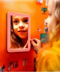 Child looking into Magnetic Locker Mirror 5x7 Inches Real Glass With Strong Magnetic Backing Pink Small Mirror For School Lockers