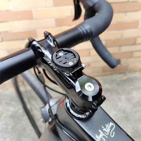 Out Front Bike Stem Mount For One And One Eighth Inch Steerer Tube Fits Garmin Edge Wahoo Elemnt Bryton Rider Stages Dash Hammerhead Karoo Adjustable Angle For Heads Up Data View On Road And Mountain Bikes mounted on a bike.