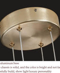 Geometric Linear LED Pendant Light Featuring Sleek Gold Finish Dimmable 3 Color Options Abstract Hanging Design close-up of aluminum base with bright finish.