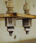 Close-up of installed brass grease fittings for industrial machinery maintenance.