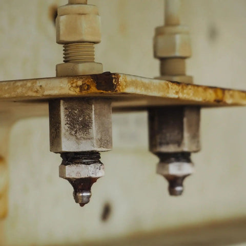 Close-up of installed brass grease fittings for industrial machinery maintenance.