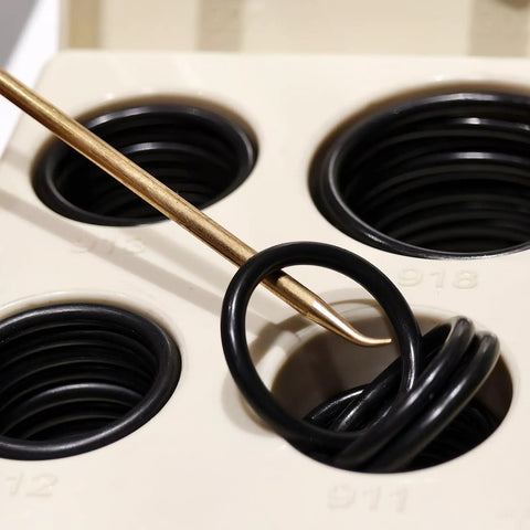 Close-up of Hydraulic O Ring Seal Kit Buna N 90D 212 Piece Assortment with brass pick tool inserted in O-ring slot.