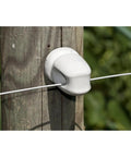 Zareba white ceramic lag-screw insulator installed on a wood post with fencing wire