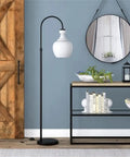 Dope Arc Floor Lamp With Glass Shade In Blackened Bronze And White Milk Glass Modern Standing Lamp For Living Room Bedroom And Home Office Decor Seventy Inch Tall With Eight Foot Cord And E26 Base next to a mirror