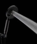 Neo Exhilaration High Pressure Handheld Shower Head With 2 GPM Flow Matte Black, spraying water in dark background