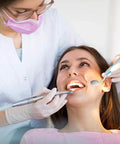 Two Pack LED Lighted Dental Mirrors For Self Check And Oral Care With Anti Fog Curved Angle Design, Dentist Grade Illumination, Easy On Off Button, ABS Handle, Great For Home Dental Exams And Easy Peasy Tooth Inspections. Dentist using an LED dental mirror during a tooth exam.