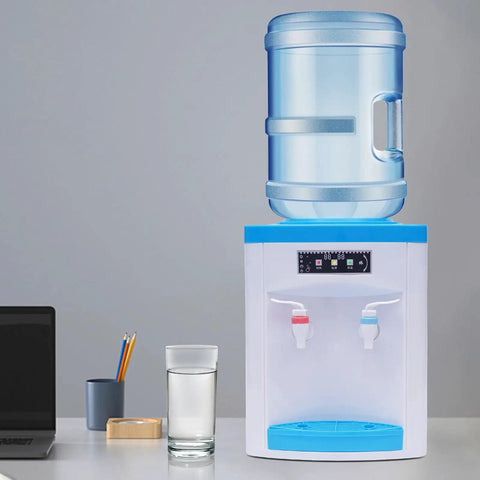 Compact 110V 550W Portable Countertop Water Dispenser With Hot And Cold Water Tiny Desk Side Hydration Station on tabletop with glass