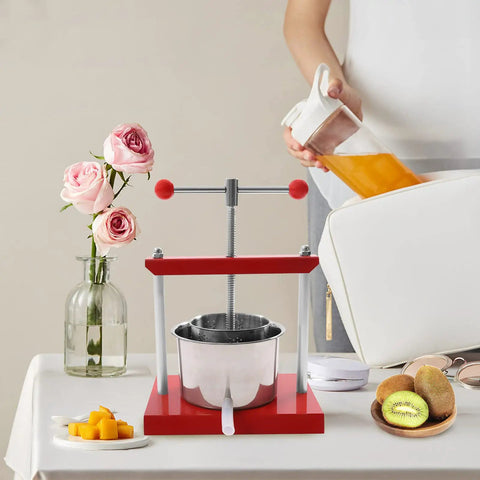 Heavy Duty Manual Fruit Wine Press Built Like A Tank Food Grade Stainless Steel Apple Grape Juicer on a table with fruits.