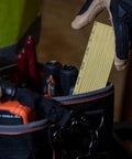 Worker taking Six Foot Folding Ruler With Inside Reading, Built Tough Fiberglass Construction, Nylon Reinforced from tool bag