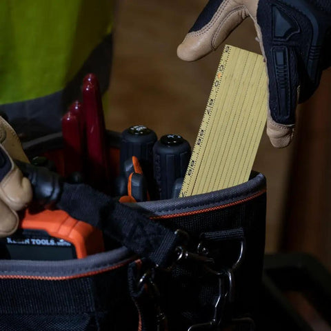 Worker taking Six Foot Folding Ruler With Inside Reading, Built Tough Fiberglass Construction, Nylon Reinforced from tool bag