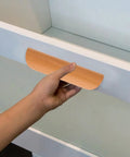 Hand holding semicircle solid wood cabinet handle 64mm beech from Set of 6, visible on kitchen wardrobe, sturdy furniture hardware