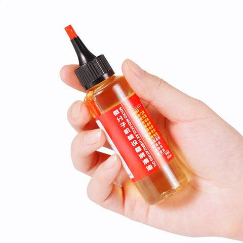 Hand holding a 60ml bottle of door hinge lubricant penetrating oil for no more squeaks and rust prevention, multi purpose lubricant for fans.