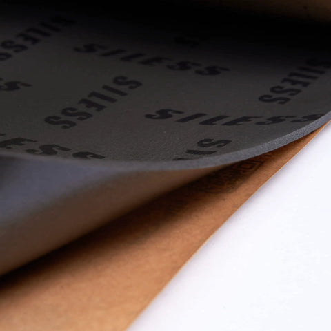 Close-up of Badass 4mm Car Sound Deadening Heat Insulation Mat showing layered adhesive and closed cell foam material.