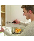 Man using a tool from the 12V Max Drill And Home Tool Kit 60 Piece Set with Compact Lithium Ion Drill for cabinet repair.