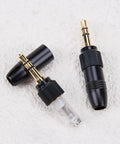 Two Pack Gold Plated DIY 3.5mm Stereo Jack Plug Adapter With M6 Threaded Lock for Headphones and Audio Converters on white surface