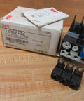 Single overload relay T25DU32 24-32 A 3-pole thermal motor protector with box on wooden surface