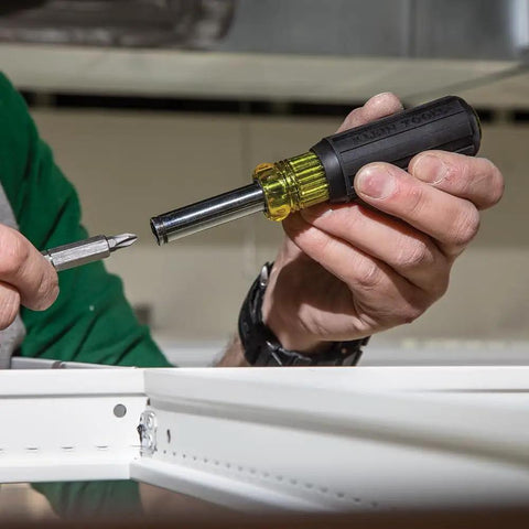 Person using Magnetic Multi-Bit Screwdriver And Nut Driver, 11-In-1 With Eight Bit Tips And Three Nut Driver Sizes in workshop.