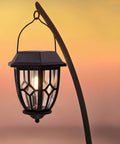 Dope Hexagon Solar Lanterns Outdoor Waterproof Hanging Lights with warm LED filament bulb against a sunset.
