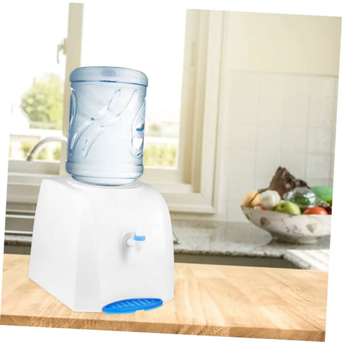 Compact Desktop Cold Water Dispenser With Easy Press Button Operation for home office use, on a kitchen counter with fruit bowl