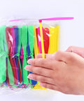 Flying Helicopter Toy Set With 20 Propellers And 20 Rods Hand being rubbed to launch pink propeller, colorful set visible