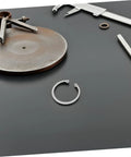 Five Piece Stainless Steel Internal C Clip Snap Ring Set for Grooved Shafts and Studs displayed with tools on a table.