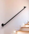 Heavy Duty Black Powder Coated Pipe Stair Handrail Six Foot Wall Mounted Corner Railing For Indoor Steps Loft Balcony Or Porch Deck With Rock Solid Grip And Tough As Nails Frame mounted on an indoor wall.