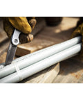 3 1/4 Inch Drop Point Pocket Knife With Aluminum Handle cutting pipes, showcasing D2 Steel Blade and smooth ball-bearing deployment