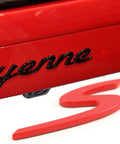 Close-up of Red S Logo Emblem For Porsche Tailgate Badge Dope Compatible With 911 991 992 718 Cayenne Panamera Macan Boxster Turbo Taycan 2013 To 2025 Easy Install Rear Trunk Lid Badge, showing installation near Cayenne lettering.