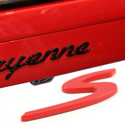 Close-up of Red S Logo Emblem For Porsche Tailgate Badge Dope Compatible With 911 991 992 718 Cayenne Panamera Macan Boxster Turbo Taycan 2013 To 2025 Easy Install Rear Trunk Lid Badge, showing installation near Cayenne lettering.