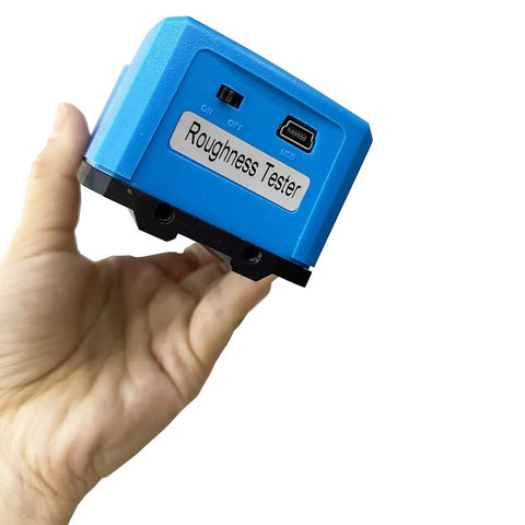 Grab And Go Digital Surface Roughness Meter With Curved Sensor And Steel Stand For Cylindrical Parts Offering Dead Accurate Readings Plug And Play USB Connection showing handheld design and USB connection.