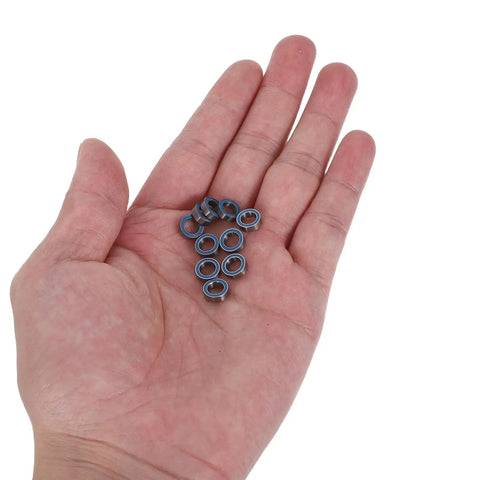 Person holding RC Ball Bearings 0.3x0.3 Inch Rubber Sealed Deep Groove Wheel Hub Bearings For Traxxas Models in hand.
